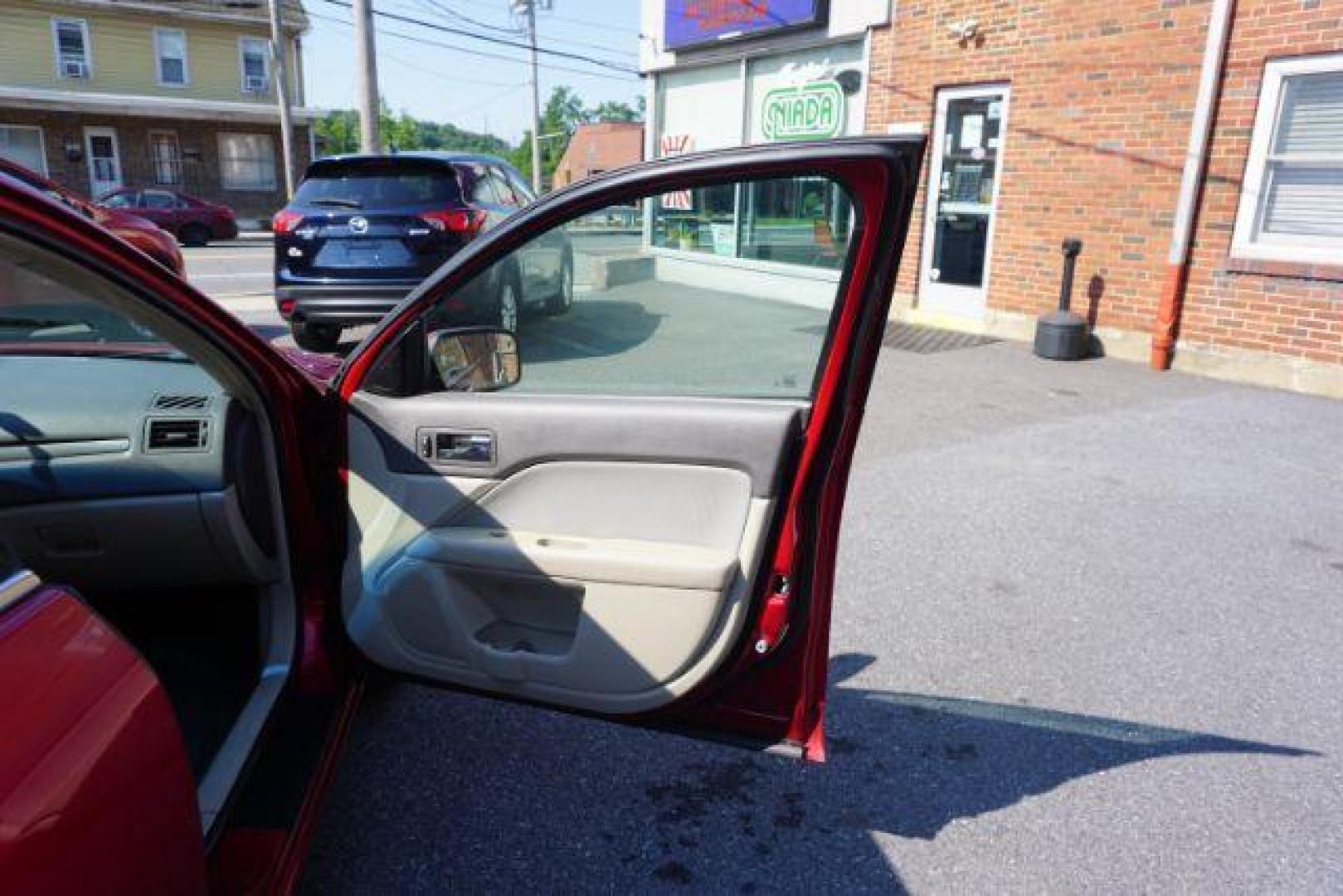 2012 Red Candy Metallic /Medium Light Stone C Ford Fusion SE (3FAHP0HA1CR) with an 2.5L L4 DOHC 16V engine, located at 312 Centre Ave, Schuylkill Haven, PA, 17972, (570) 593-5278, 40.638130, -76.177383 - Photo#46