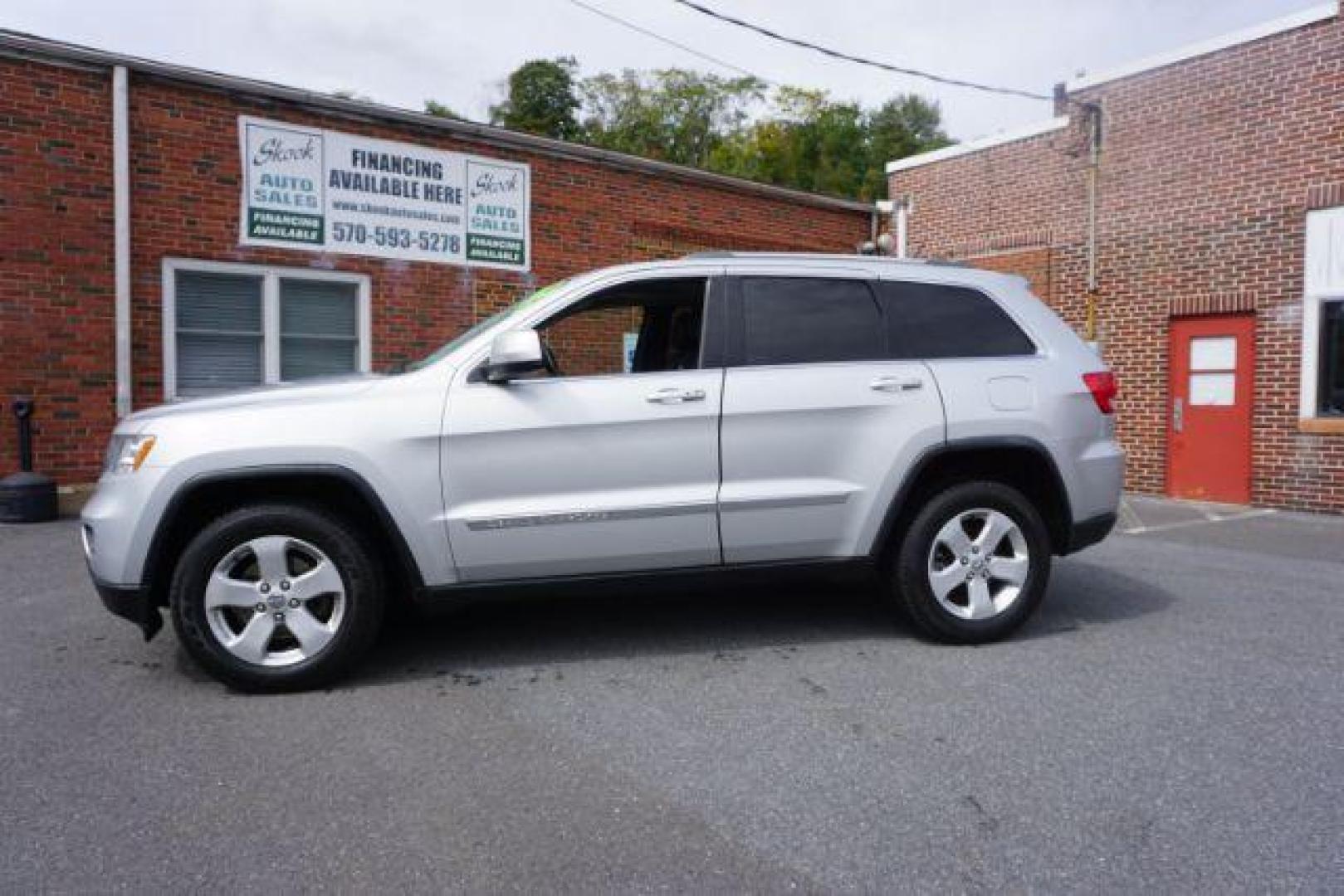 2012 Bright Silver Metallic /Black Leather Interior Jeep Grand Cherokee Laredo 4WD (1C4RJFAG2CC) with an 3.6L V6 DOHC 24V engine, 5-Speed Automatic transmission, located at 312 Centre Ave, Schuylkill Haven, PA, 17972, (570) 593-5278, 40.638130, -76.177383 - automatic climate control, back up camera, heated front seats, leather seats, navigation, power liftgate, rear parking sensors - Photo#1