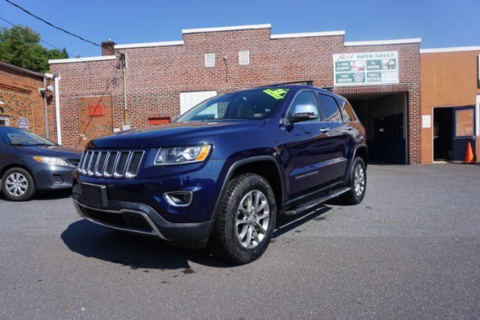 2015 True Blue Pearlcoat /Light Frost Beige/Black Jeep Grand Cherokee Limited 4WD (1C4RJFBG9FC) with an 3.6L V6 DOHC 24V engine, 8-Speed Automatic transmission, located at 312 Centre Ave, Schuylkill Haven, PA, 17972, (570) 593-5278, 40.638130, -76.177383 - adaptive cruise control, adv tech pkg, back up camera, blind spot monitor, collision avoidance system, heated front seats, lane departure warning, leather seats, navigation system, power liftgate, power sunroof, rear parking sensors, universal garage door opener - Photo#1