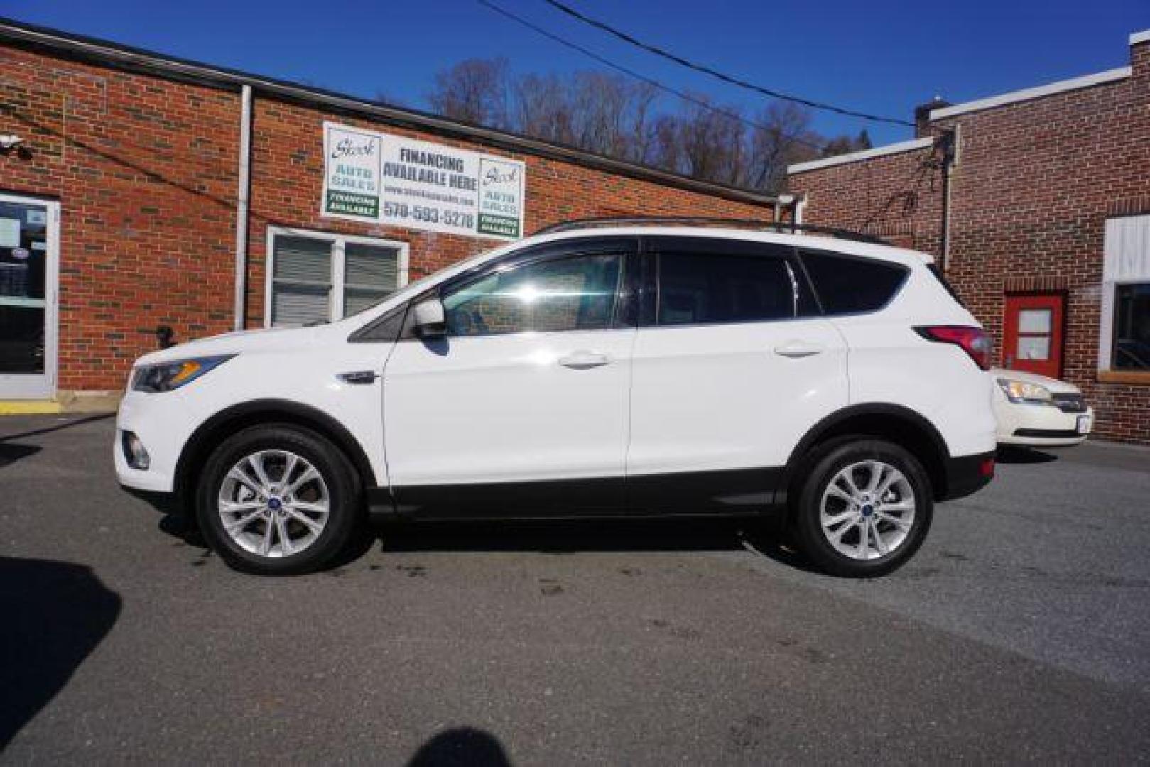 2017 Oxford White /Charcoal Black Ford Escape SE (1FMCU9GDXHU) with an EcoBoost 1.5L I-4 gasoline direct injection engine, located at 312 Centre Ave, Schuylkill Haven, PA, 17972, (570) 593-5278, 40.638130, -76.177383 - blind spot monitor, heated exterior mirrors, heated front seats, leather seats, luggage rack, navigation, power passenger seat, power sunroof, rear parking sensors - Photo#0